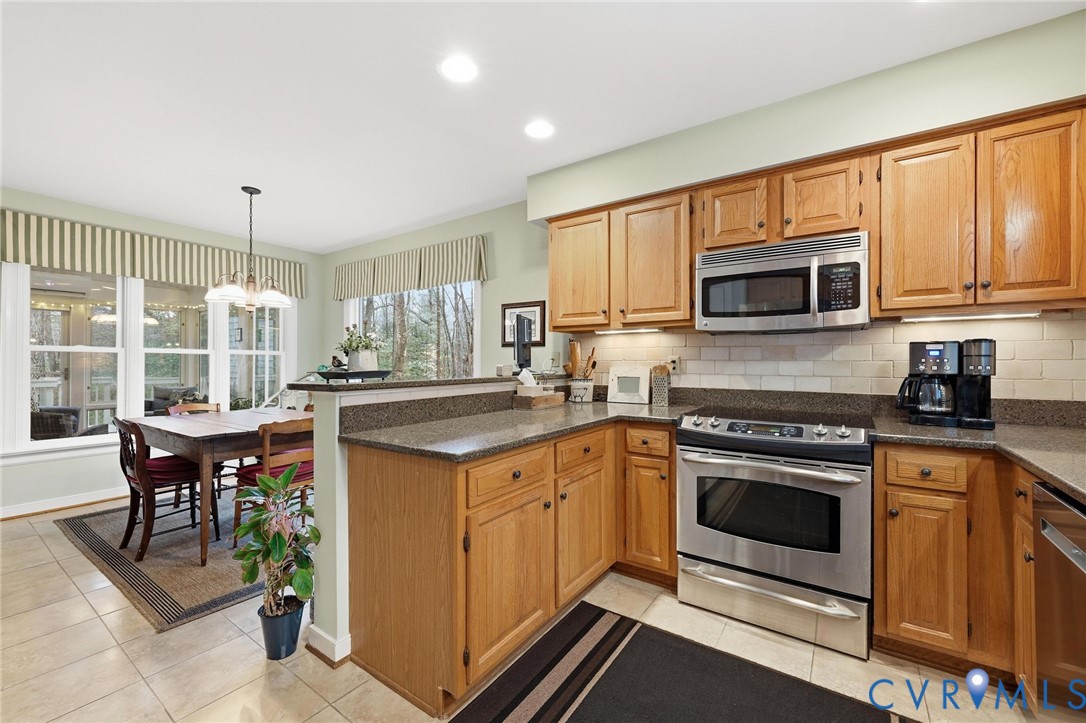 5601 Sandstone Ridge Road Midlothian, VA 23112 - Photo 12 of 43 a kitchen with stainless steel appliances granite countertop a stove a sink and a microwave