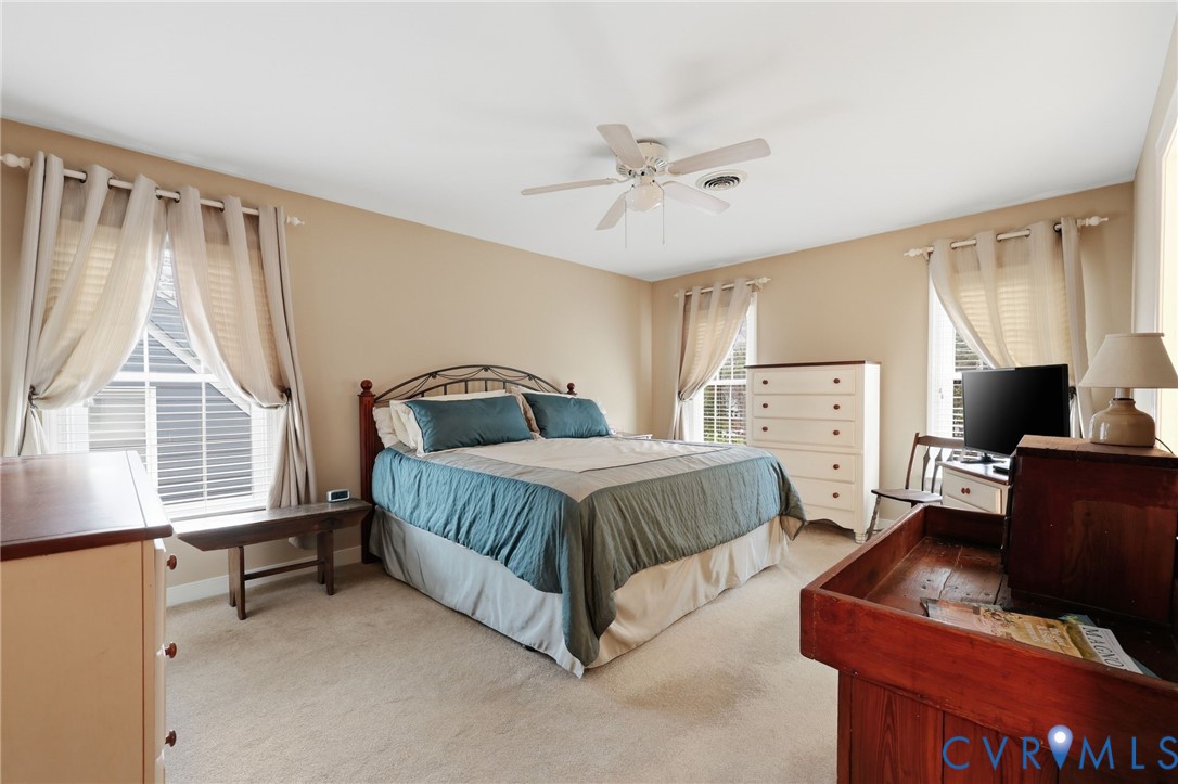 5601 Sandstone Ridge Road Midlothian, VA 23112 - Photo 19 of 43 a bedroom with a bed flat screen tv and a window