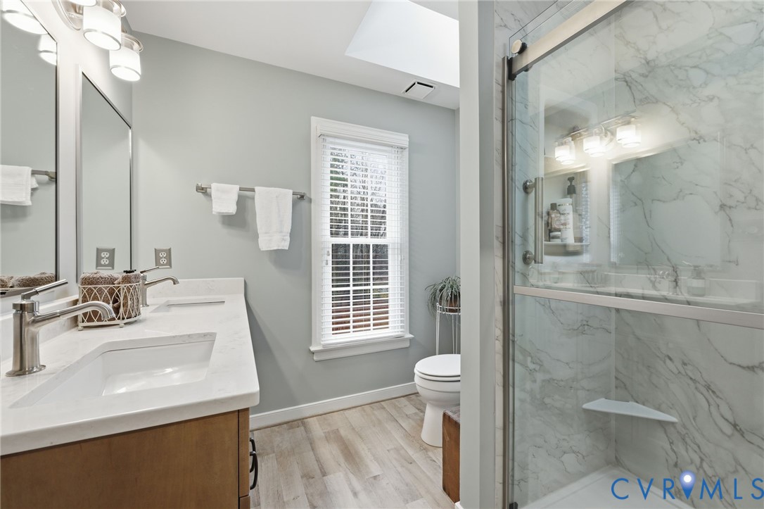 5601 Sandstone Ridge Road Midlothian, VA 23112 - Photo 21 of 43 a bathroom with a sink a toilet and shower