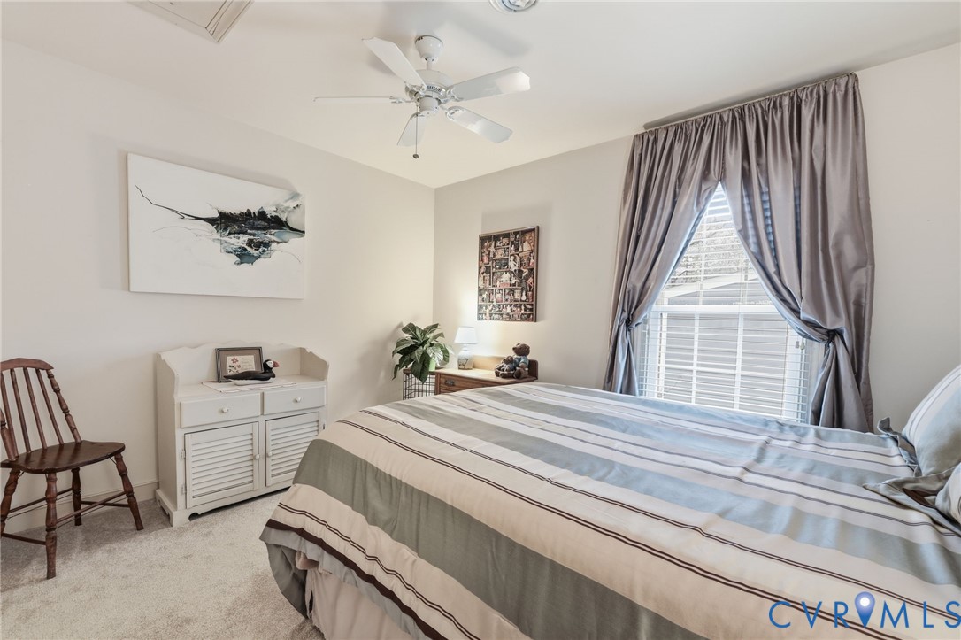 5601 Sandstone Ridge Road Midlothian, VA 23112 - Photo 22 of 43 a bedroom with a bed and a chandelier
