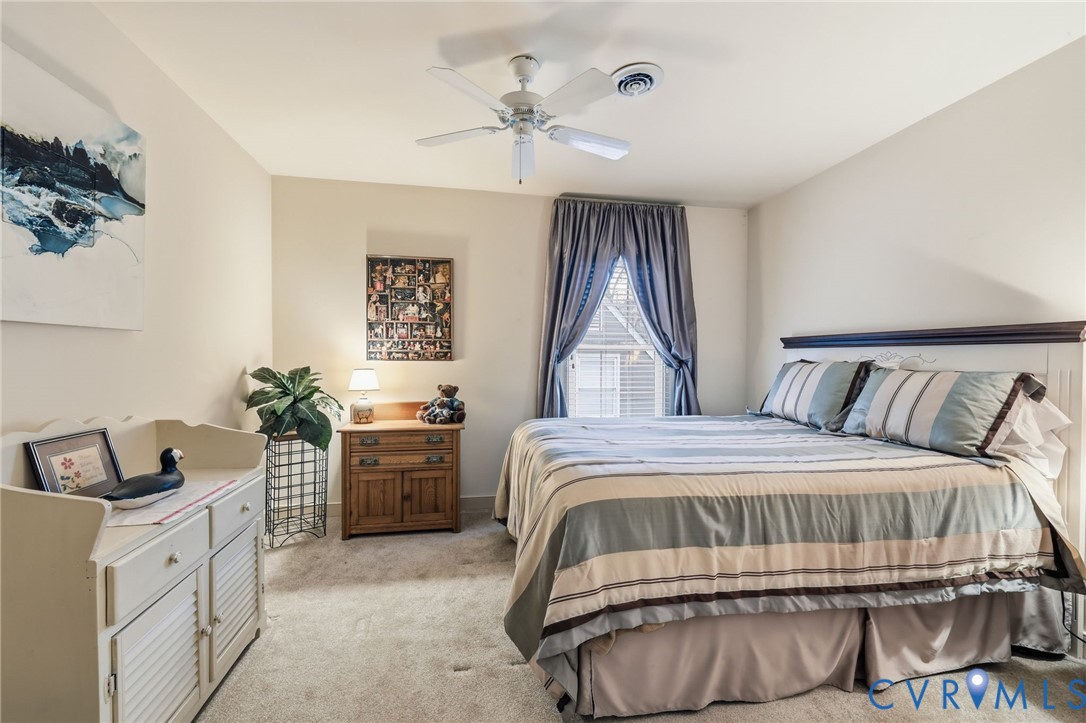 5601 Sandstone Ridge Road Midlothian, VA 23112 - Photo 23 of 43 a bedroom with a bed and a chandelier