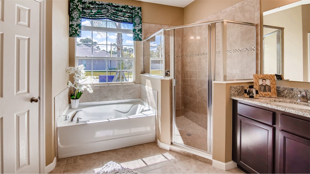 71 52nd Square Vero Beach, FL 32968 - Photo 7 of 16 a bathroom with a bathtub and a shower