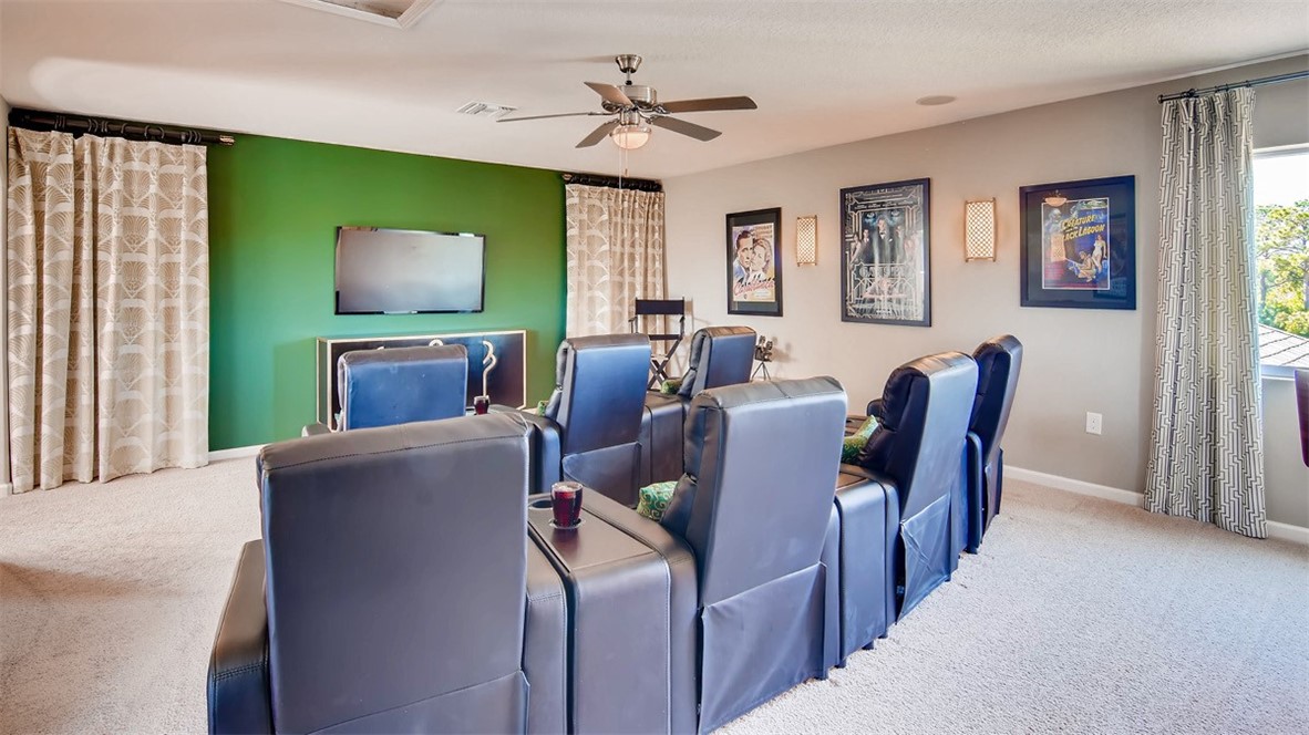 71 52nd Square Vero Beach, FL 32968 - Photo 9 of 16 a living room with furniture a flat screen tv and a fireplace