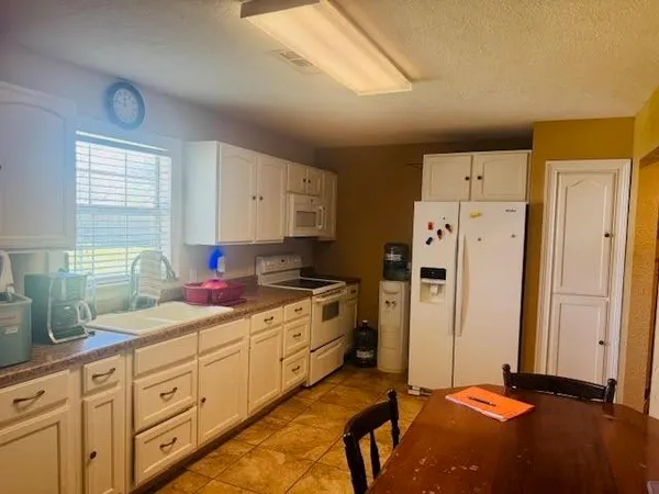 a kitchen with stainless steel appliances a refrigerator sink and cabinets