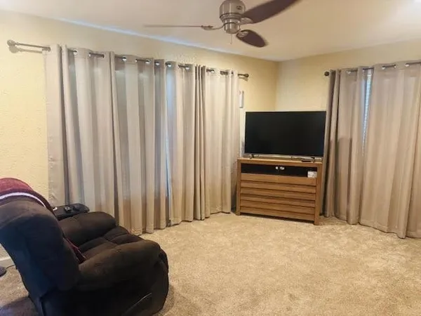 a bedroom with furniture and a flat screen tv