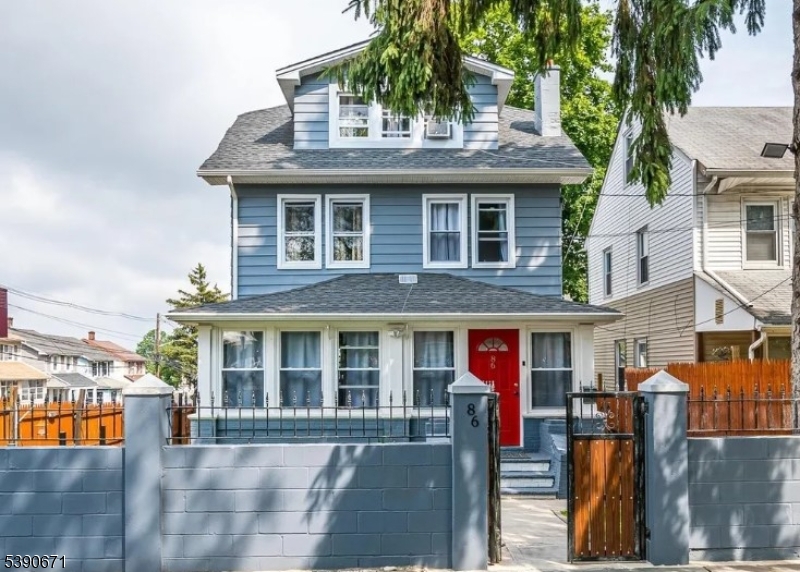 86 Mead Street Newark, NJ 07106 - Photo 1 of 8 a front view of a house with lots of green space