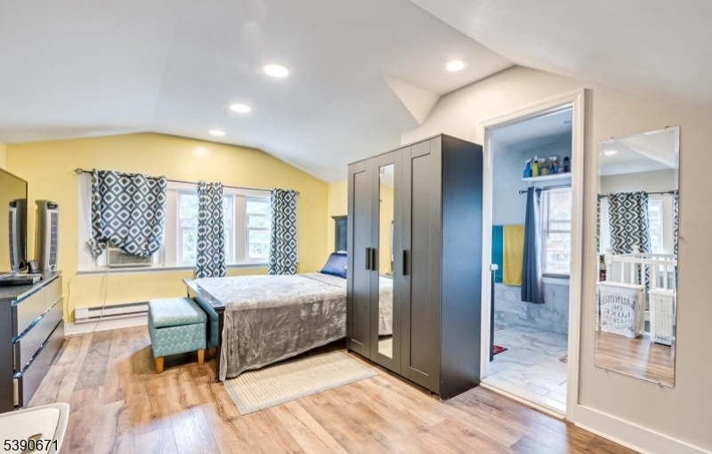 86 Mead Street Newark, NJ 07106 - Photo 4 of 8 a spacious bedroom with a bed and wooden floor