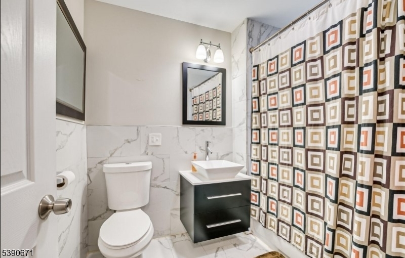 86 Mead Street Newark, NJ 07106 - Photo 5 of 8 a bathroom with a toilet sink shower and mirror