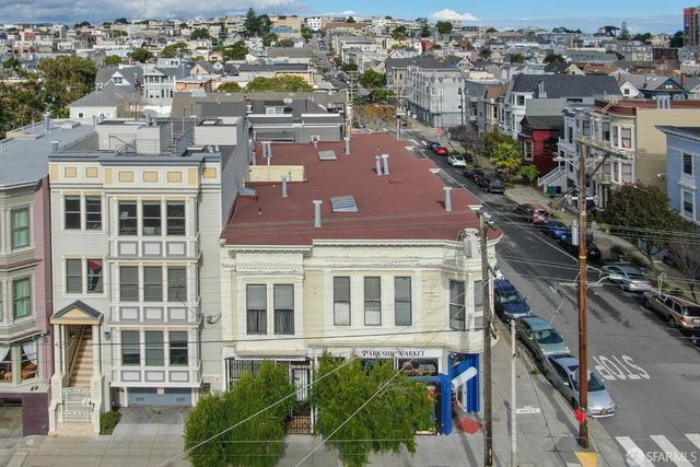 an aerial view of residential houses with outdoor space