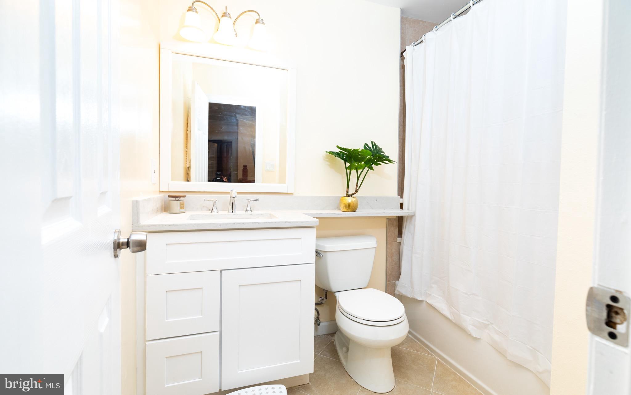 8586 Tyrolean Way Springfield, VA 22153 - Photo 11 of 18 a bathroom with a toilet a sink and a mirror