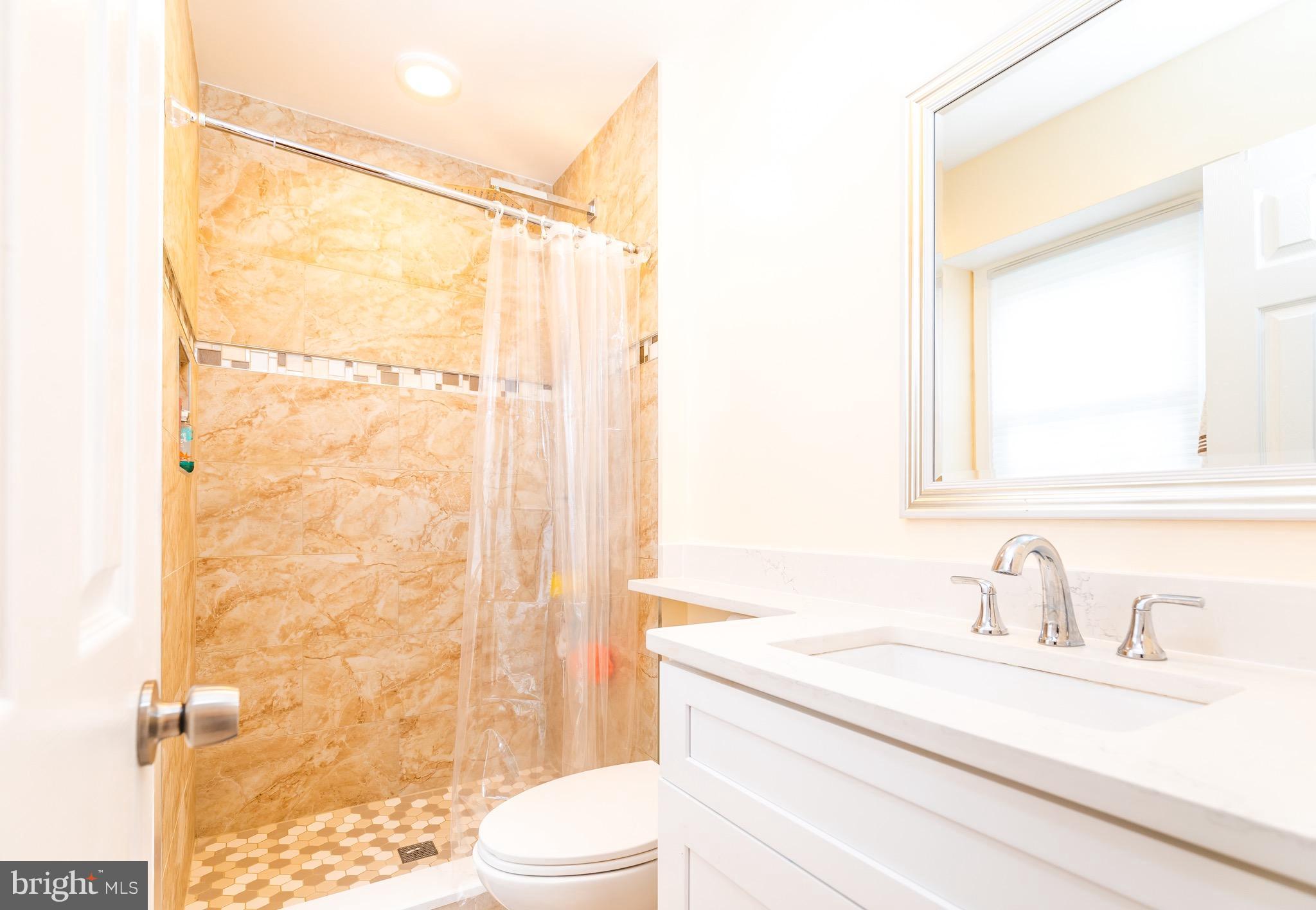 8586 Tyrolean Way Springfield, VA 22153 - Photo 12 of 18 a bathroom with a sink a toilet and shower