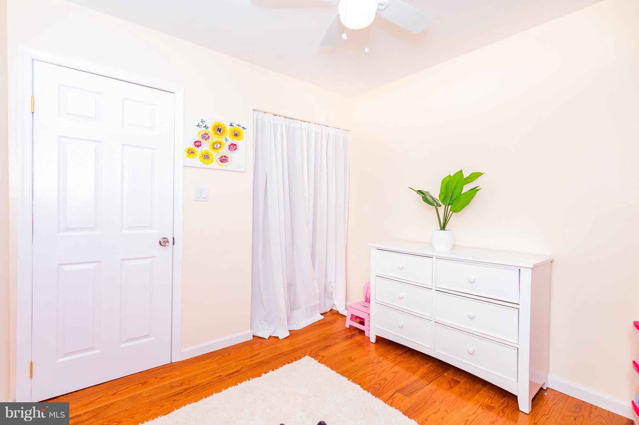8586 Tyrolean Way Springfield, VA 22153 - Photo 14 of 18 a bed room with a bed and a plant