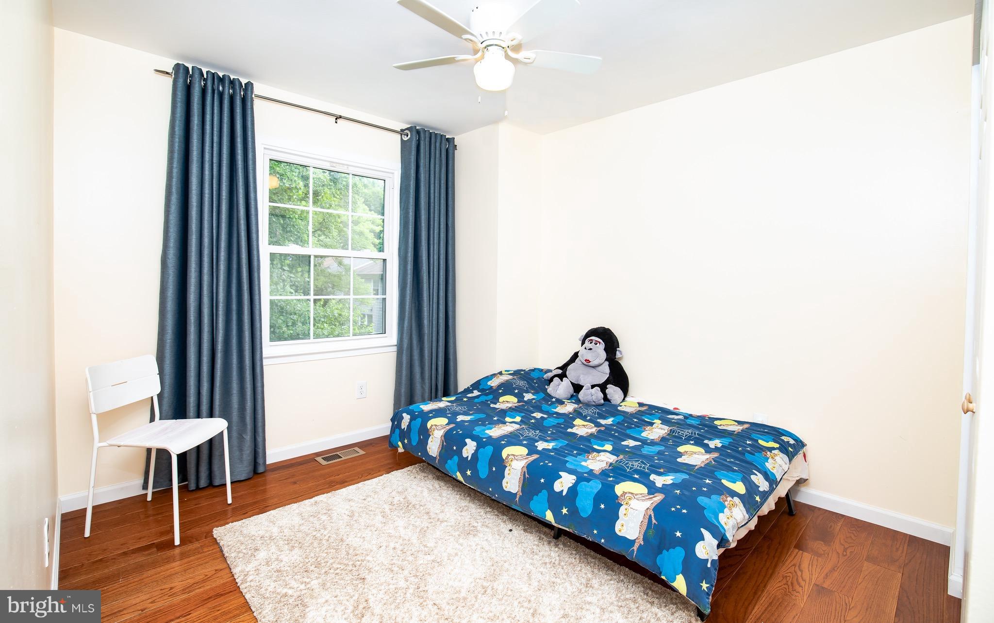 8586 Tyrolean Way Springfield, VA 22153 - Photo 15 of 18 a bedroom with a bed and a table in it