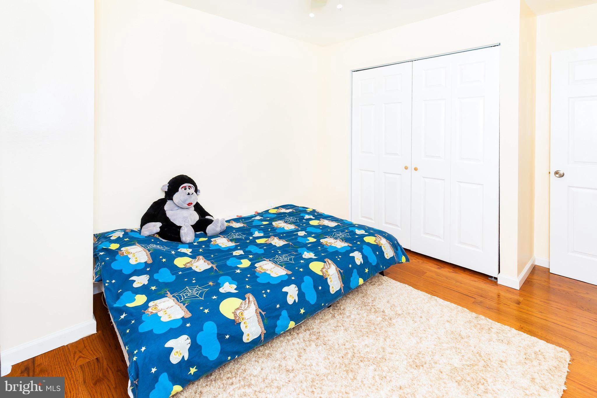 8586 Tyrolean Way Springfield, VA 22153 - Photo 16 of 18 a bedroom with a bed and a painting on the wall