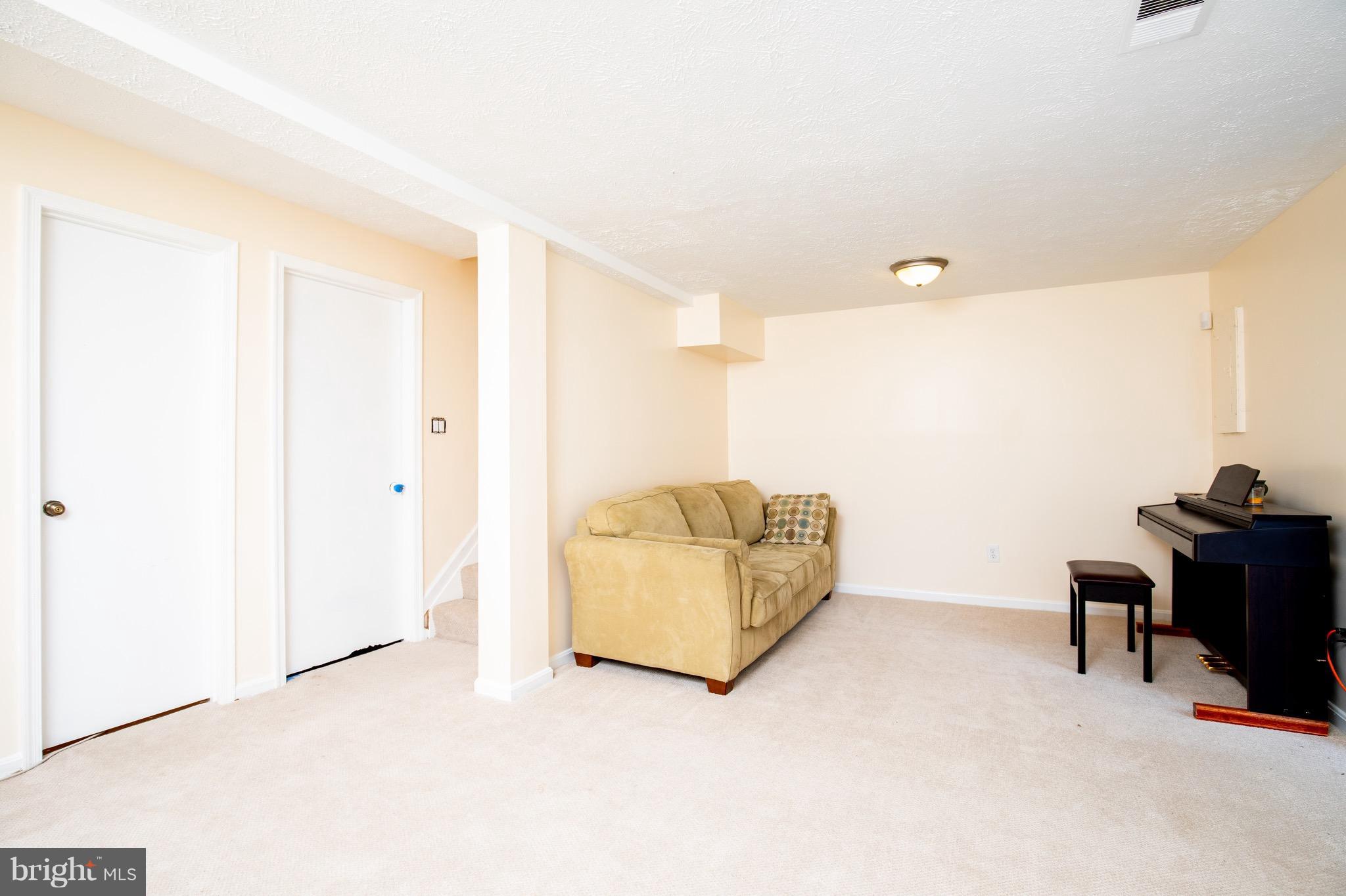 8586 Tyrolean Way Springfield, VA 22153 - Photo 17 of 18 a living room with furniture and a air conditioner vent