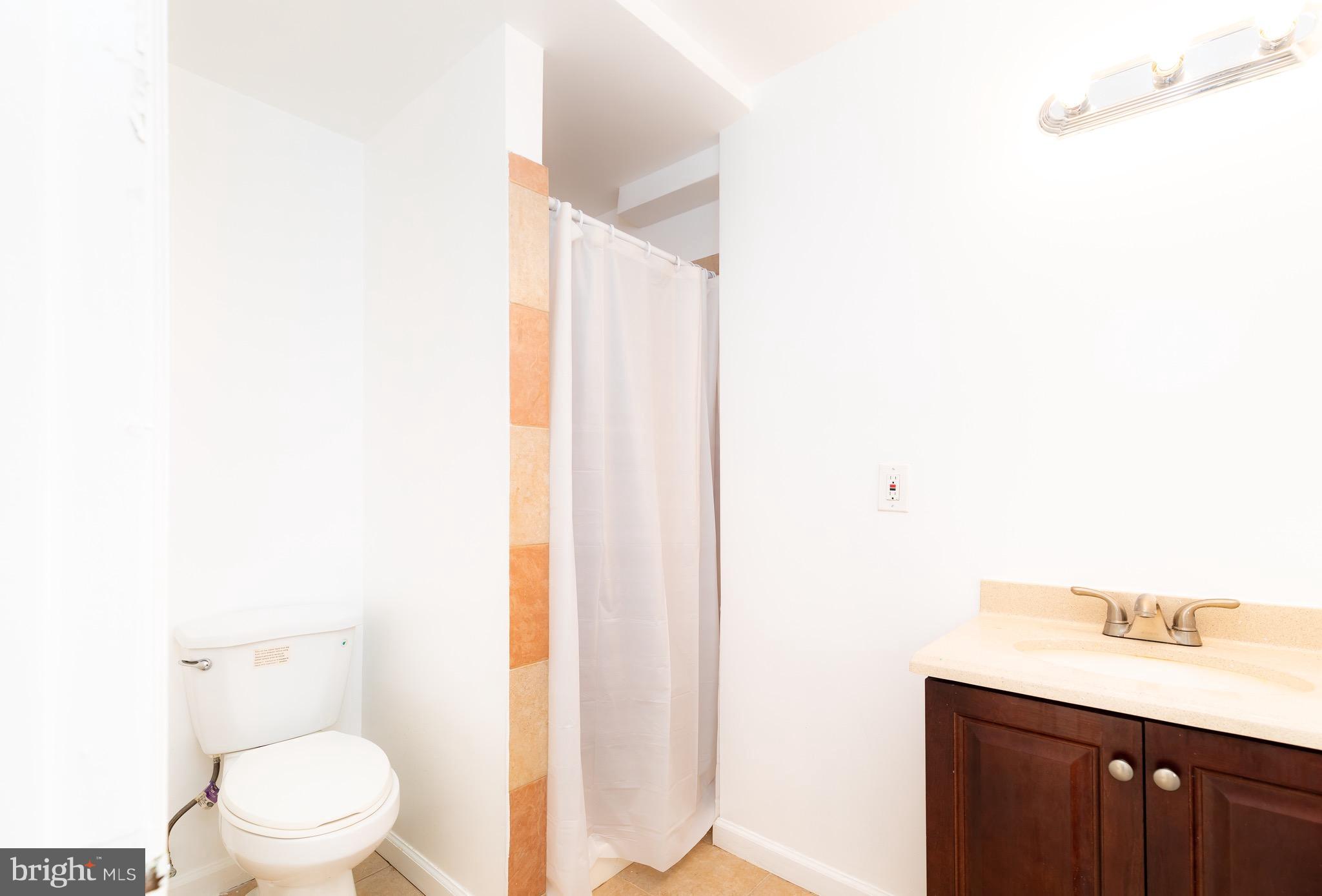 8586 Tyrolean Way Springfield, VA 22153 - Photo 18 of 18 a bathroom with a sink a toilet and a mirror