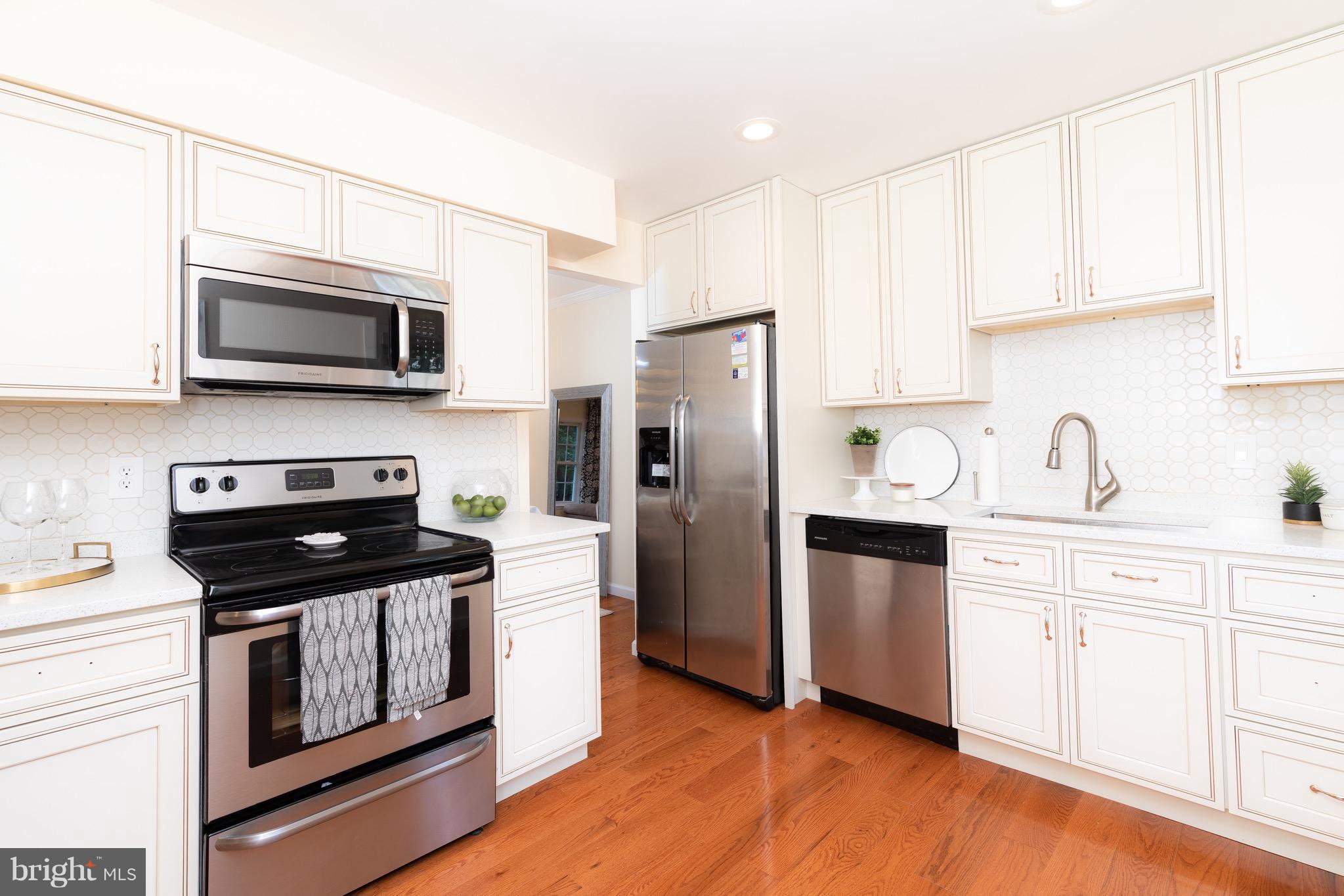 8586 Tyrolean Way Springfield, VA 22153 - Photo 3 of 18 a kitchen with stainless steel appliances a stove microwave and a refrigerator