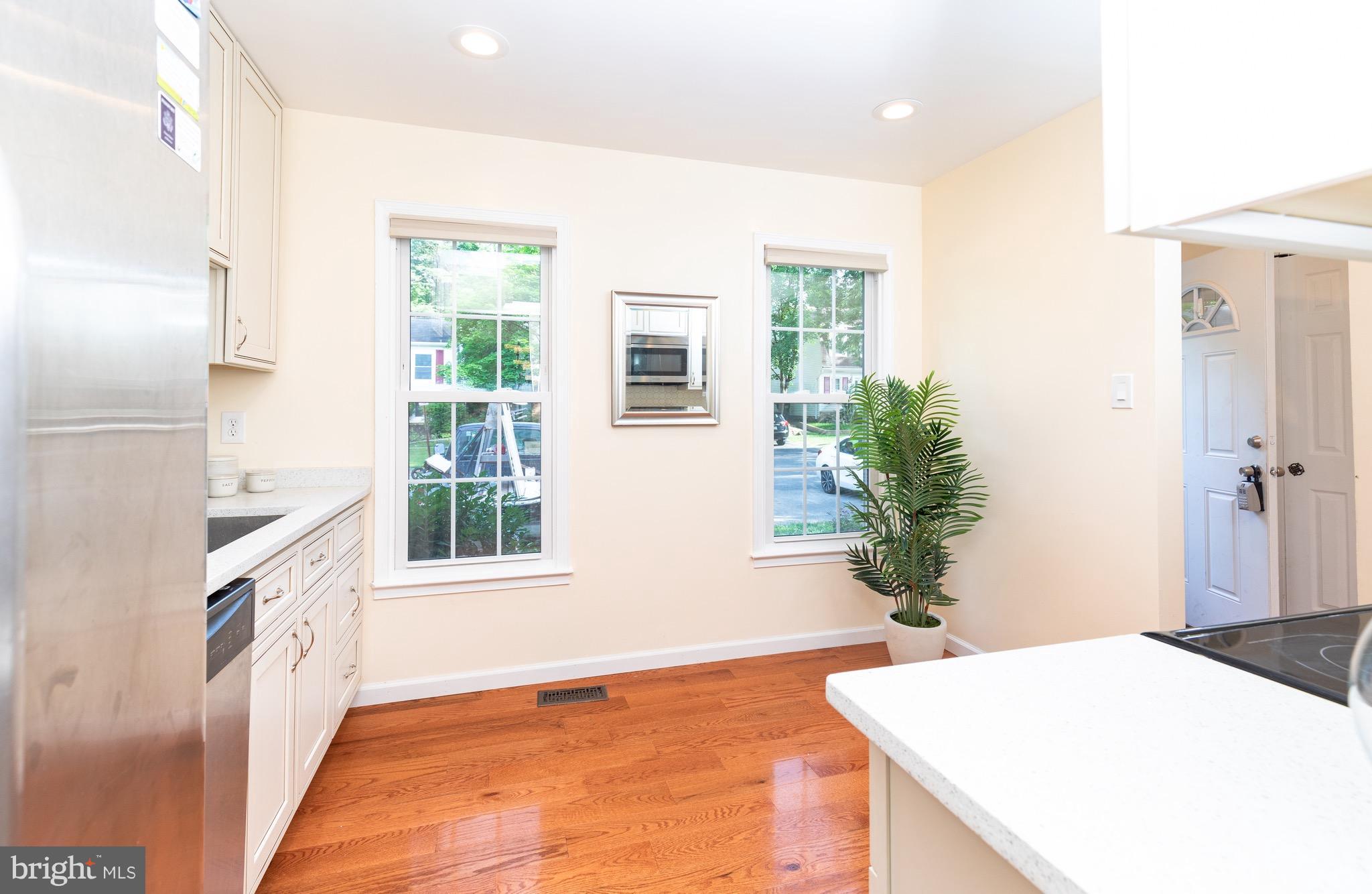8586 Tyrolean Way Springfield, VA 22153 - Photo 4 of 18 a room with a bed and a potted plant on the dresser