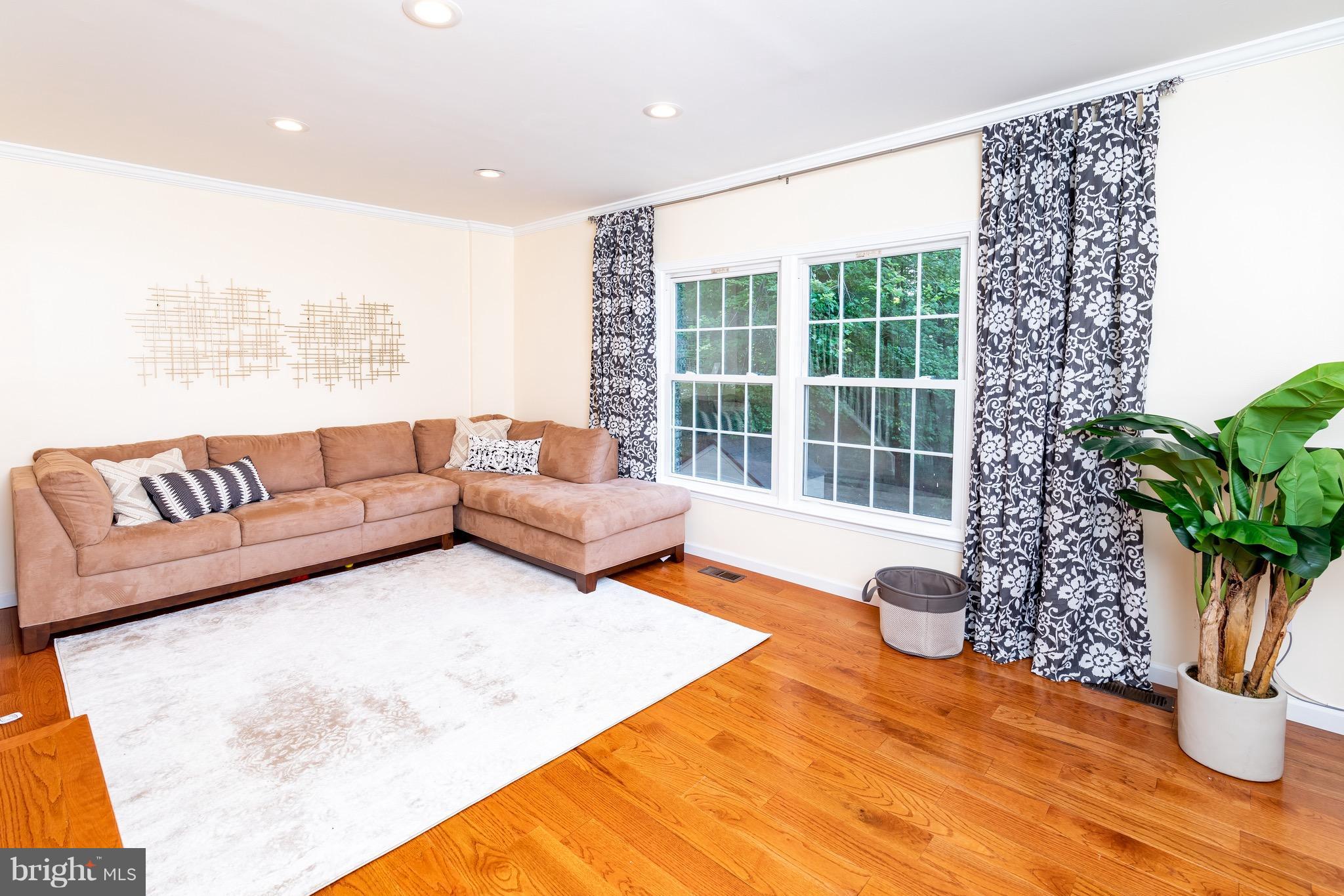 8586 Tyrolean Way Springfield, VA 22153 - Photo 5 of 18 a living room with furniture window and wooden floor