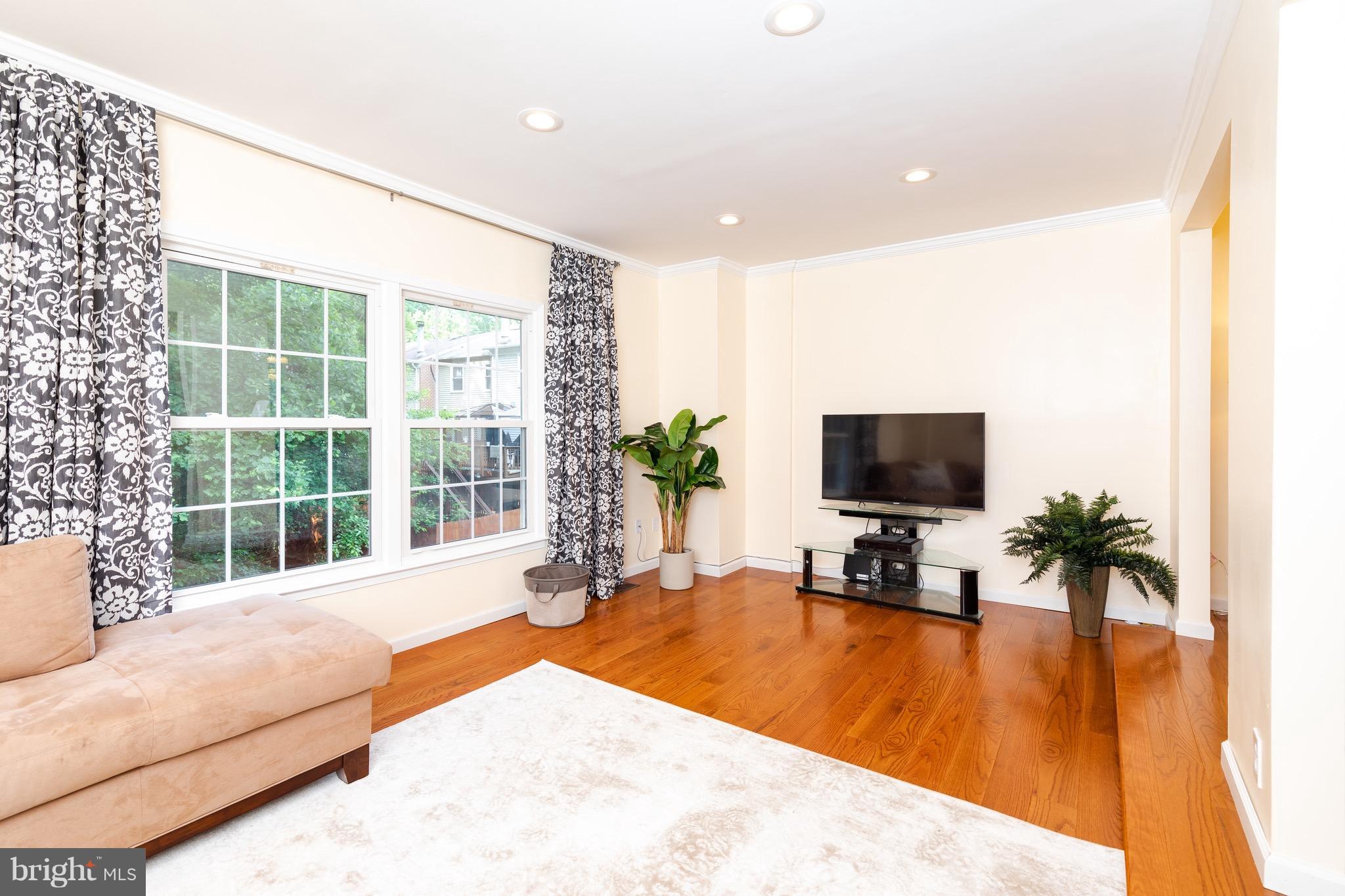 8586 Tyrolean Way Springfield, VA 22153 - Photo 6 of 18 a living room with furniture and a flat screen tv