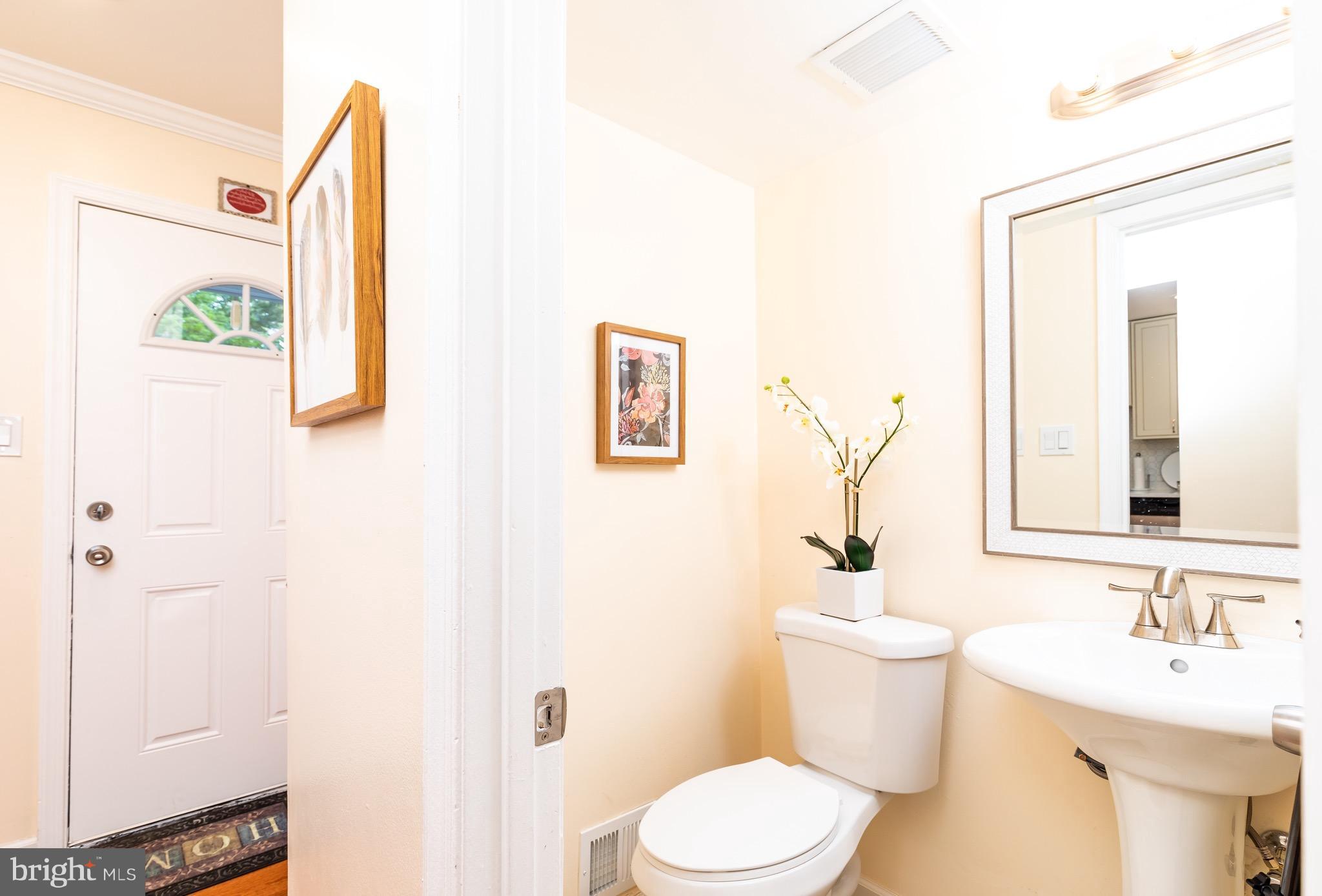 8586 Tyrolean Way Springfield, VA 22153 - Photo 8 of 18 a bathroom with a sink toilet and mirror