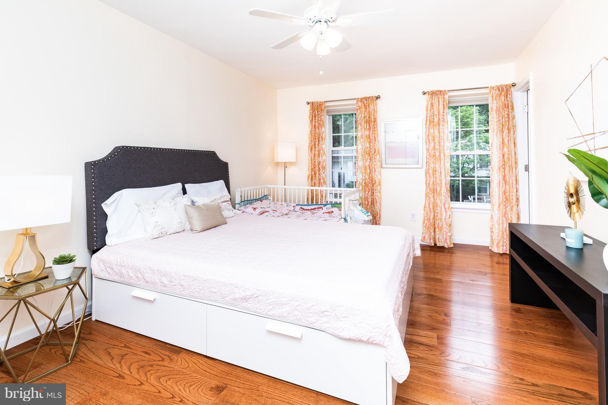 8586 Tyrolean Way Springfield, VA 22153 - Photo 10 of 18 a spacious bedroom with a bed and wooden floor