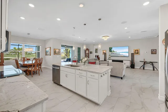 a kitchen with counter top space and living room view