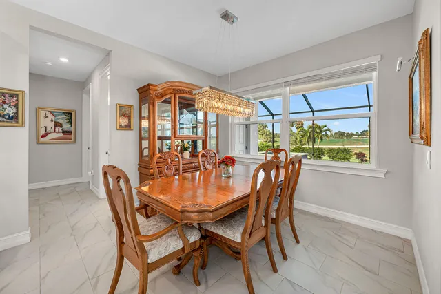 a dining room with furniture a chandelier and wooden floor