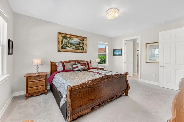 a spacious bedroom with a bed and a window