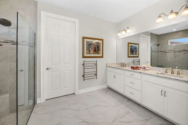a spacious bathroom with a double vanity sink mirror and bathtub