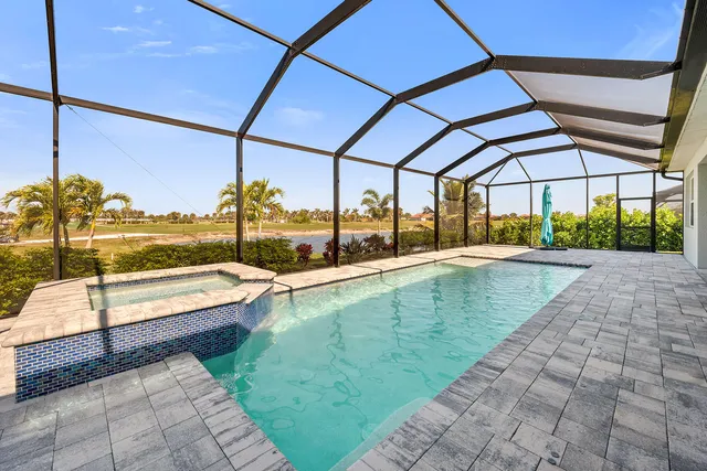 a view of a swimming pool with a lawn chairs