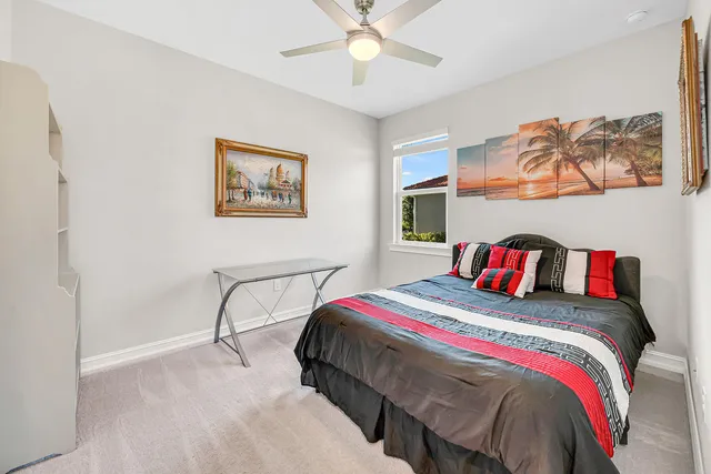 a bedroom with a bed and painting on the wall