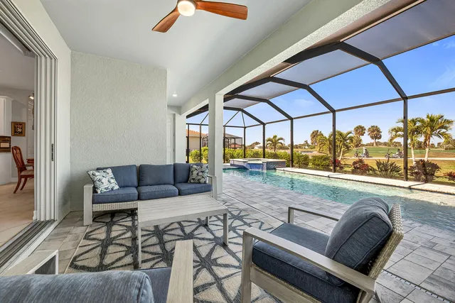 a living room with furniture and a floor to ceiling window