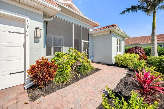 a front view of a house with a flower garden