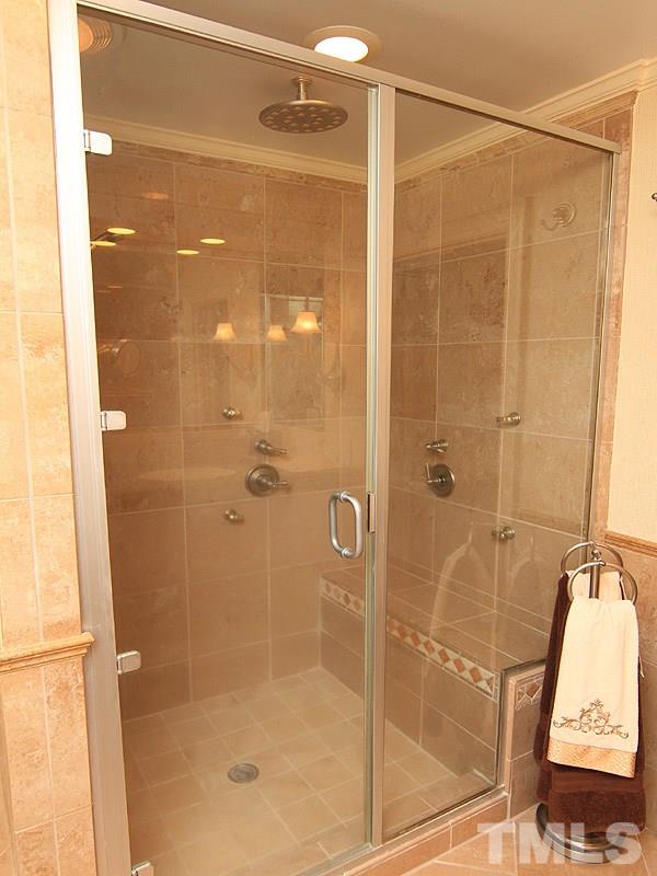 2204 Customs House Court Raleigh, NC 27615 - Photo 18 of 25 A rainhead, wall jets-you will not want to leave in this oversized shower.