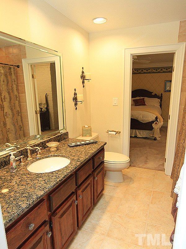 2204 Customs House Court Raleigh, NC 27615 - Photo 22 of 25 Dual vanities with granite counters and a tub/shower combo are shared between the two upstairs bedroom suites.