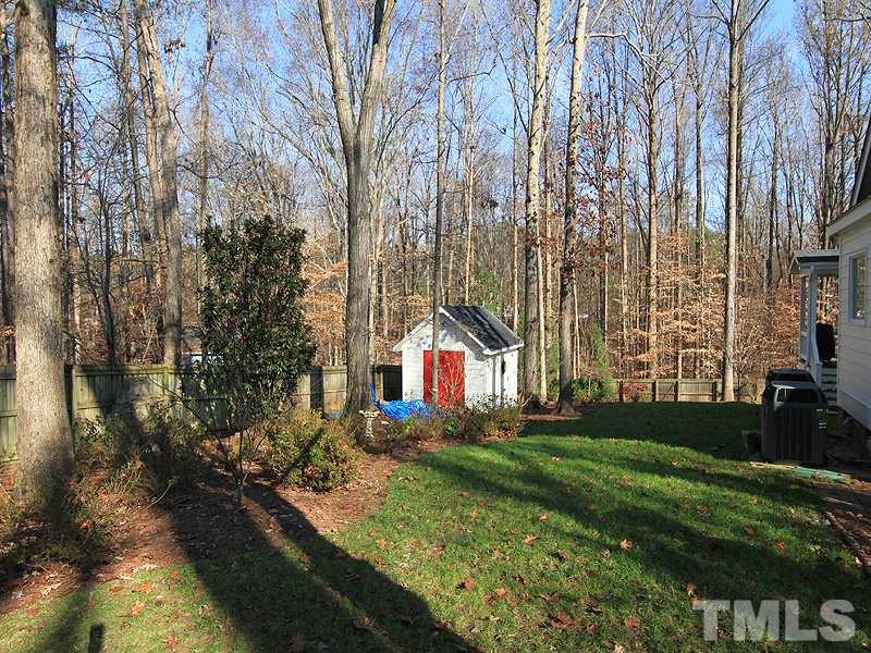 2204 Customs House Court Raleigh, NC 27615 - Photo 25 of 25 The fenced backyard is tree-lined and a custom built shed offers additional storage.