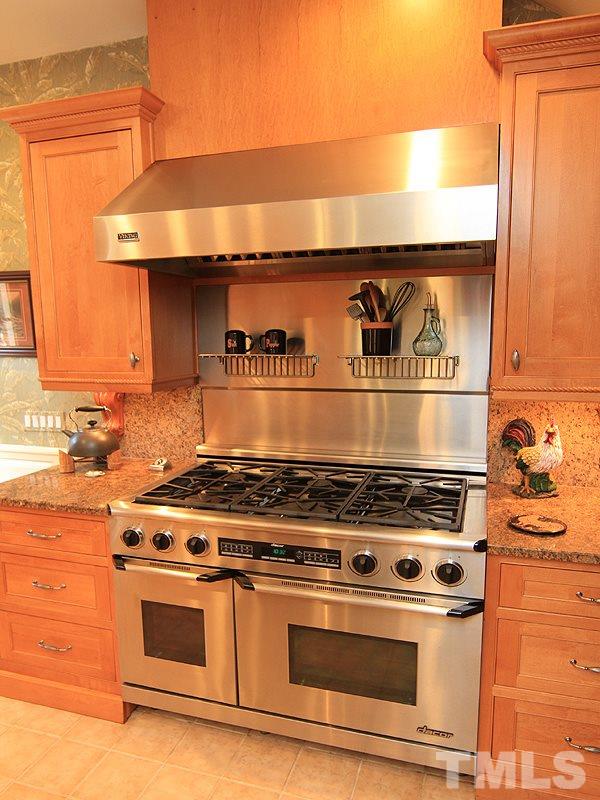 2204 Customs House Court Raleigh, NC 27615 - Photo 7 of 25 A closer photo of the cooking ability you can have. Stainless hood and backsplash behind the range, great lighting.