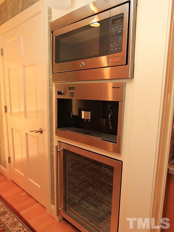 2204 Customs House Court Raleigh, NC 27615 - Photo 8 of 25 The butler's pantry is attached to the kitchen area and has a microwave, built-in Miehle Cappucino Machine and wine fridge. Beside these appliances is the door to the walk-in pantry and laundry room. Such an unbelievable home for entertaining.