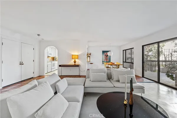 a living room with furniture and large windows