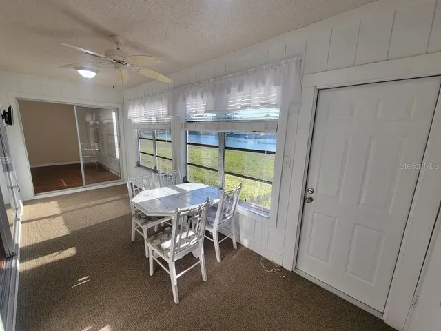 a dining room with furniture and window