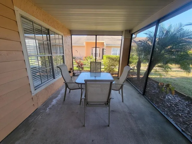 a dining room with furniture and garden view