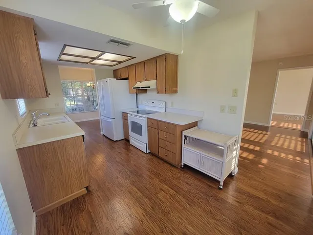 a kitchen with a sink appliances and cabinets
