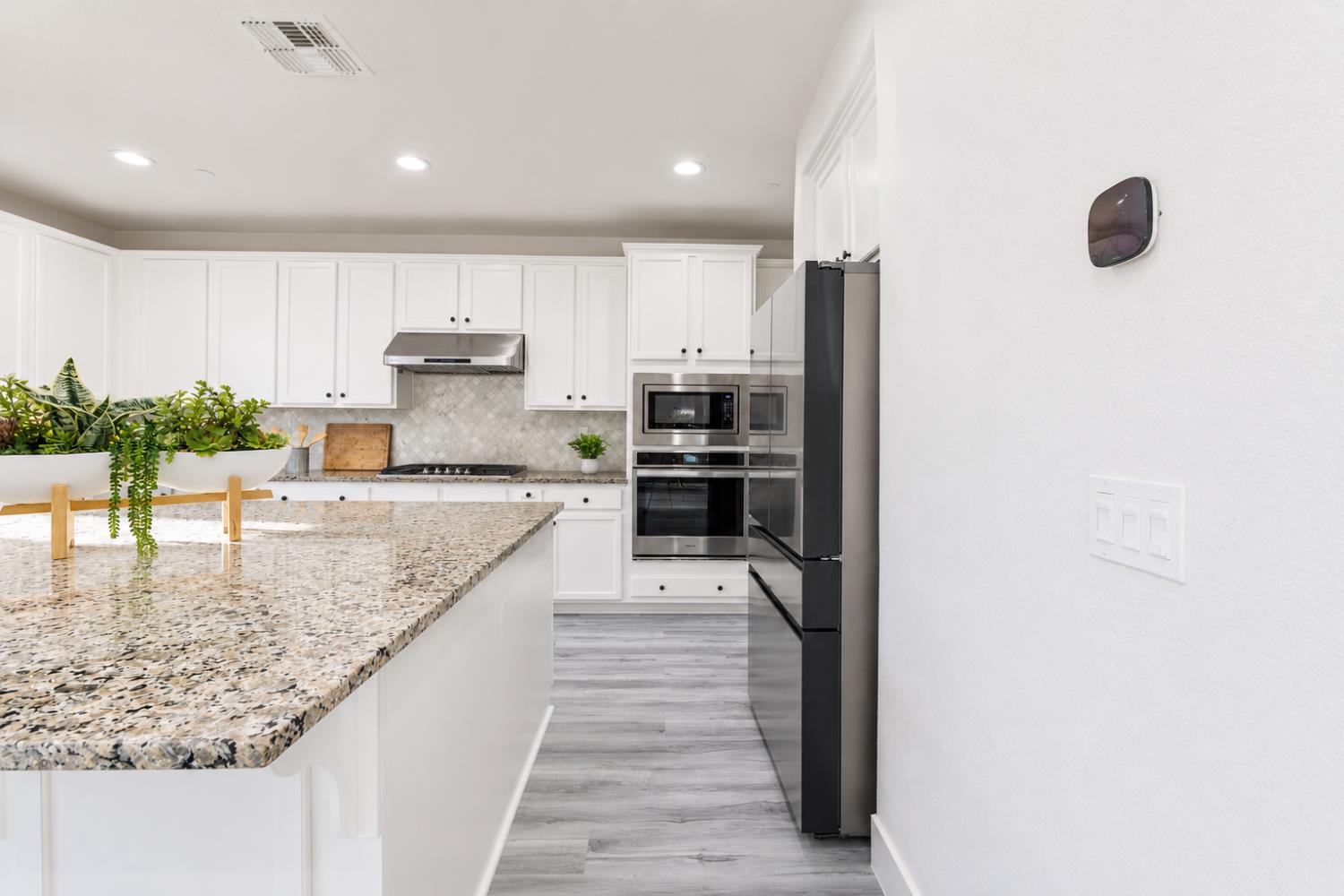 1837 South La Barbera Avenue Mountain House, CA 95391 - Photo 19 of 54 a kitchen with stainless steel appliances granite countertop a refrigerator and a sink