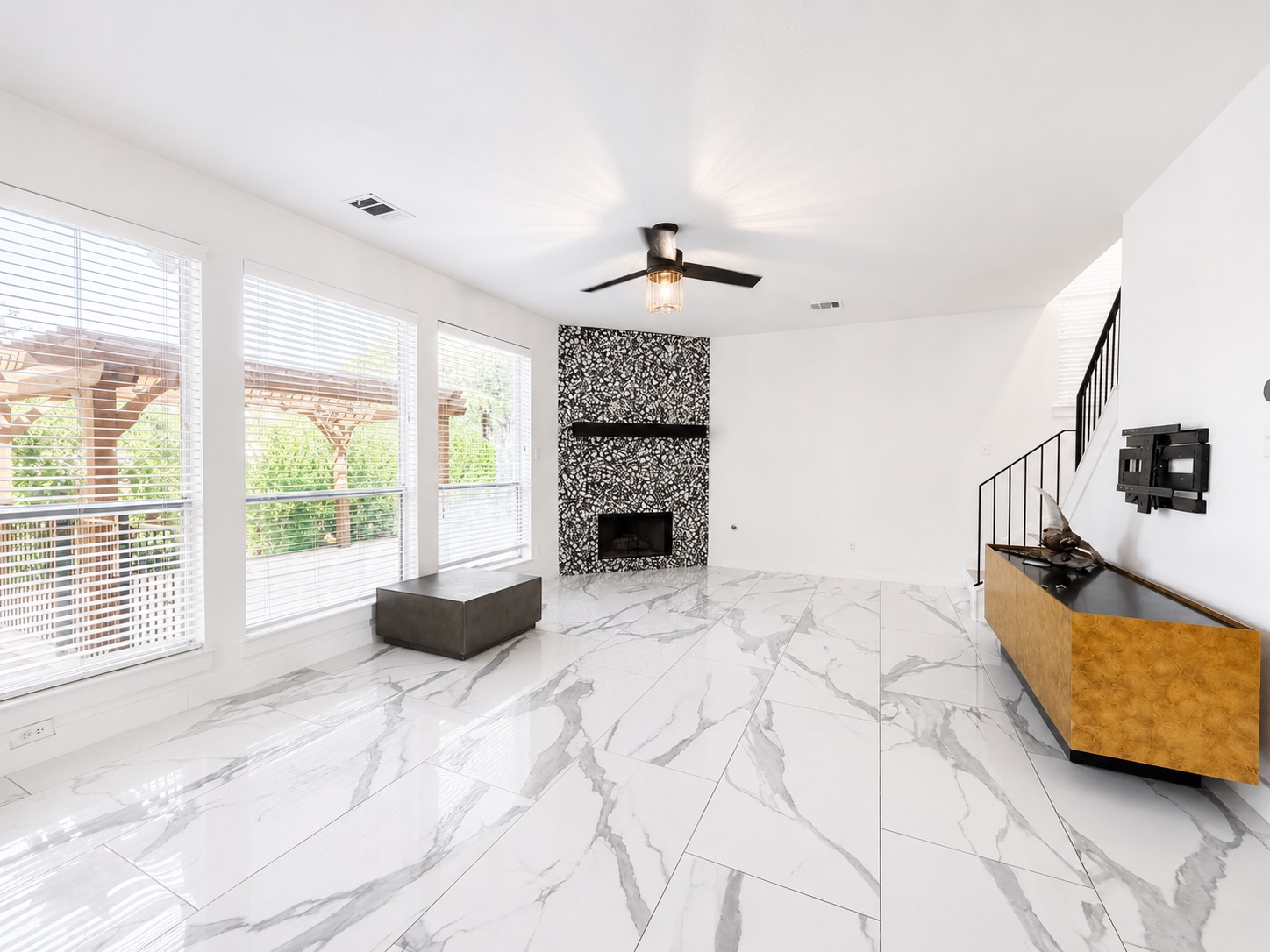 1610 Juniper Ridge Loop Cedar Park, TX 78613 - Photo 6 of 28 Polished tile flooring and a bold fireplace define this light-filled main living space.