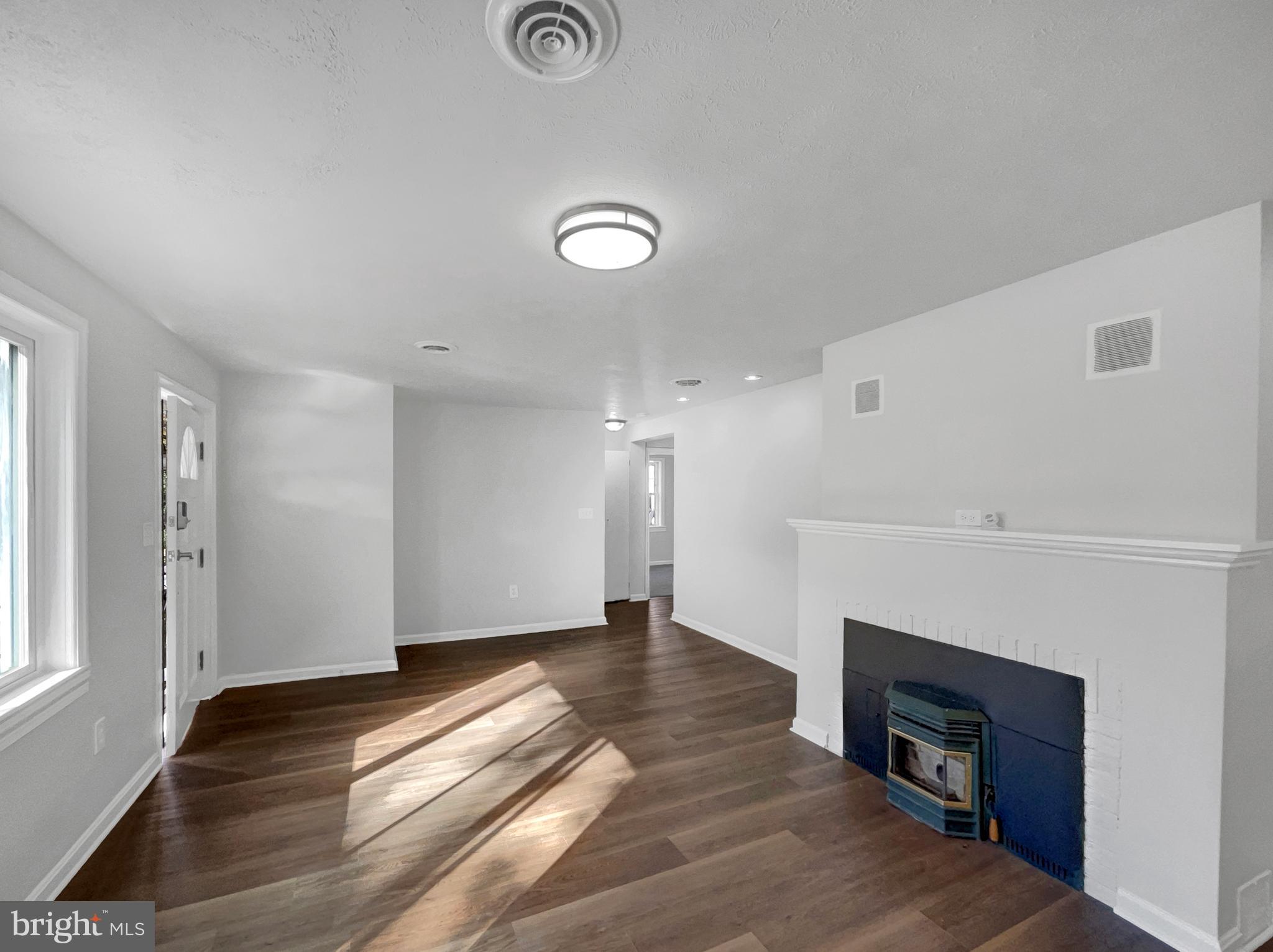 1101 Pine Lane Accokeek, MD 20607 - Photo 13 of 43 a view of an empty room with wooden floor and a window