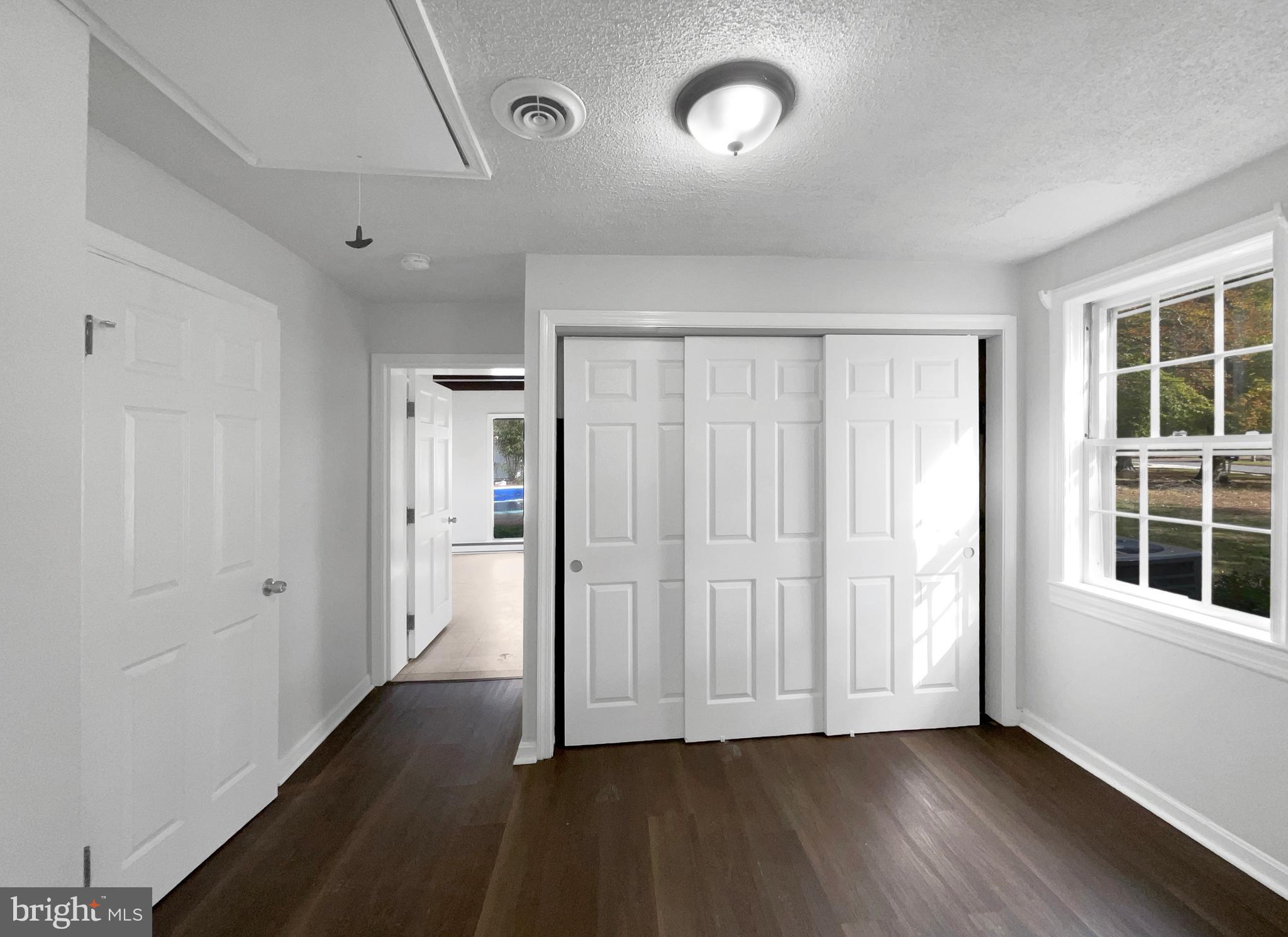 1101 Pine Lane Accokeek, MD 20607 - Photo 15 of 43 an empty room with wooden floor and windows