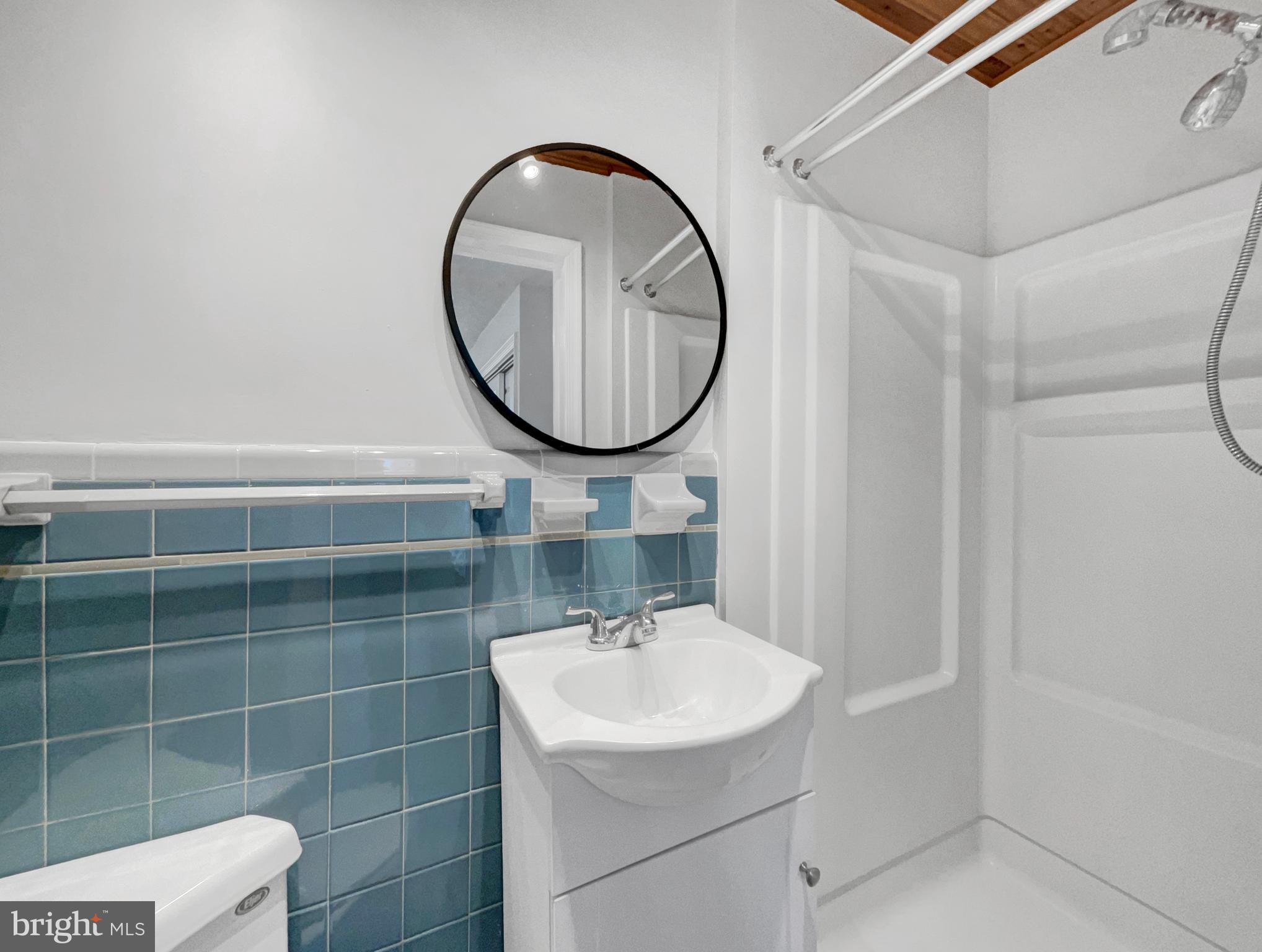 1101 Pine Lane Accokeek, MD 20607 - Photo 17 of 43 a bathroom with a sink a toilet and a mirror