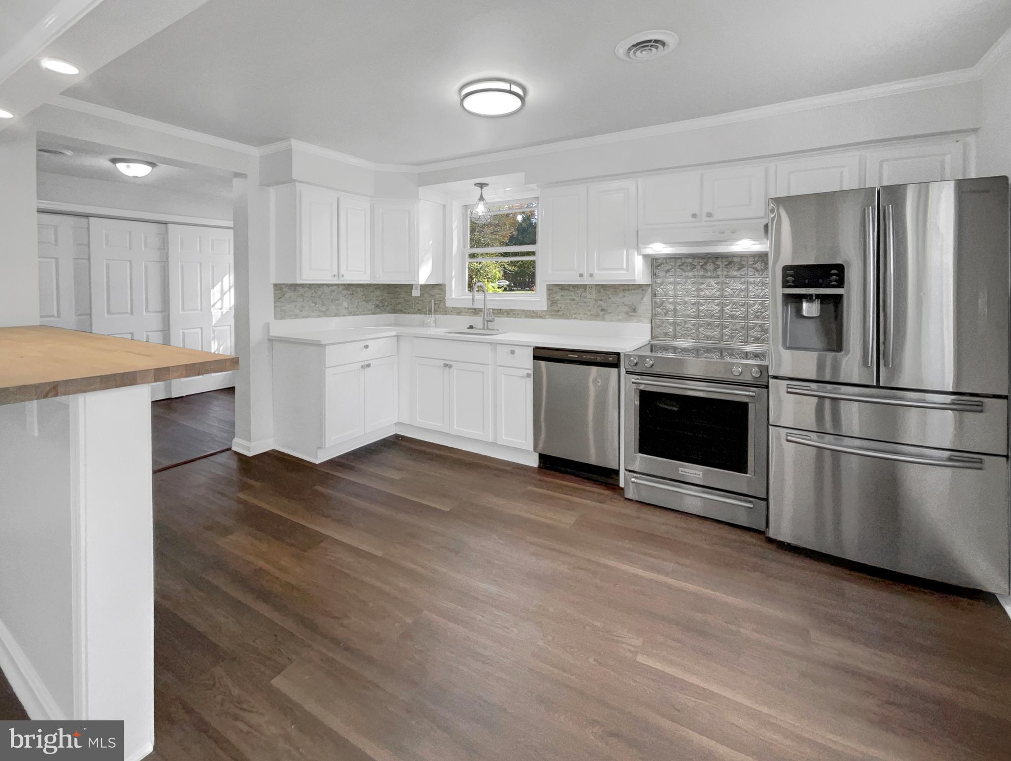 1101 Pine Lane Accokeek, MD 20607 - Photo 2 of 43 a kitchen with a refrigerator and a stove top oven