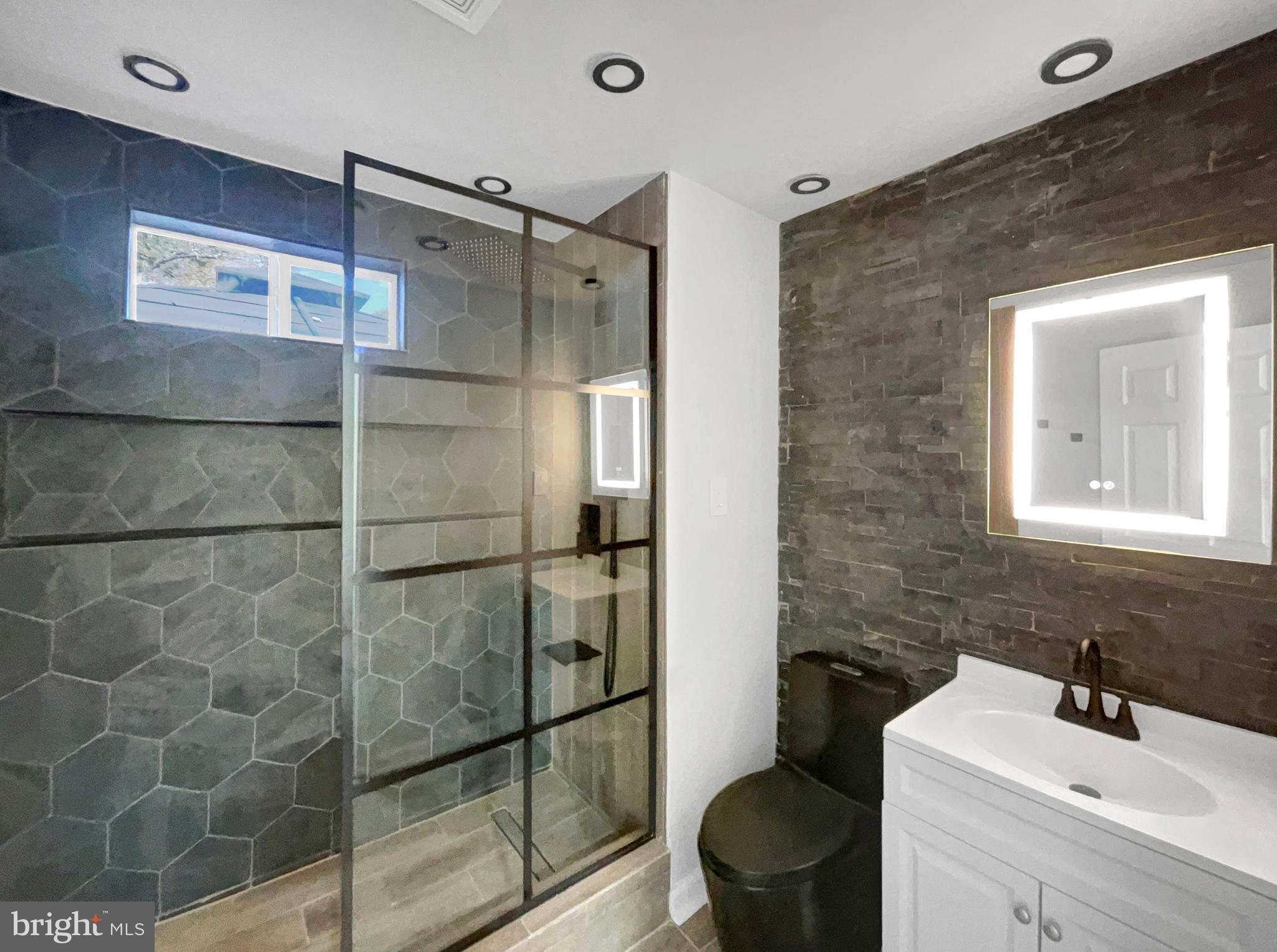 1101 Pine Lane Accokeek, MD 20607 - Photo 26 of 43 a bathroom with a toilet sink and shower